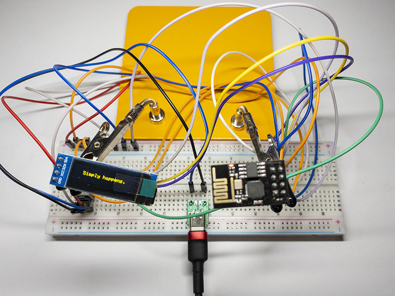 ESP-01 and OLED connected with jumper wires on a breadboard